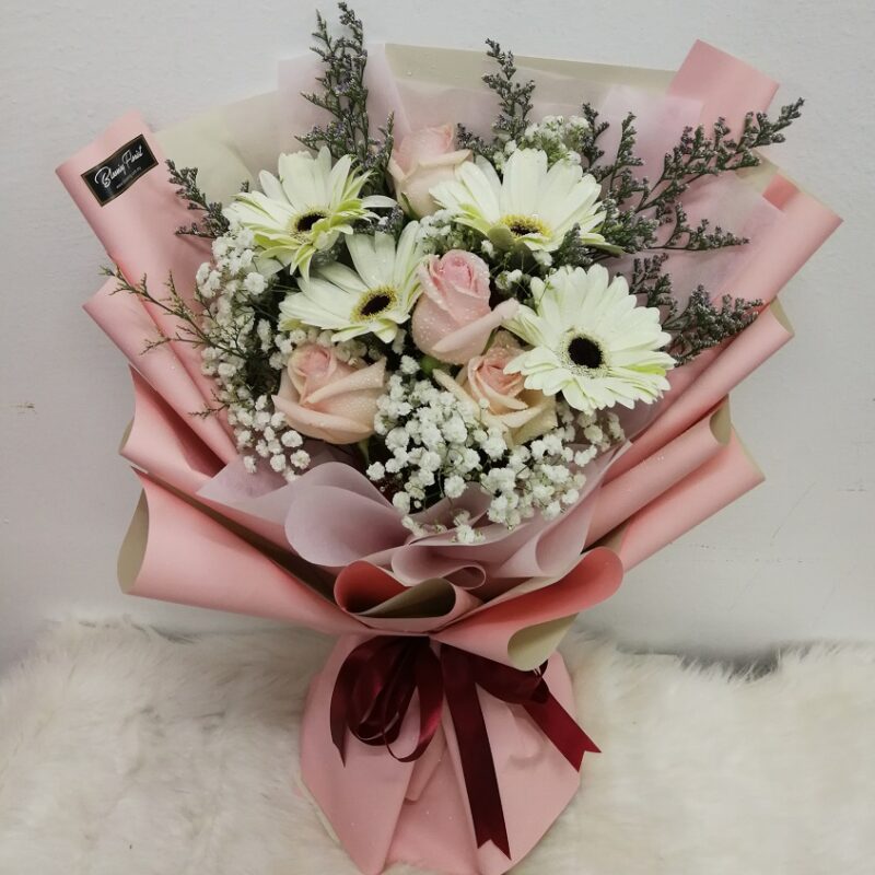 champagne roses in a hand bouquet