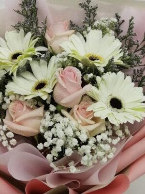 champagne roses in a hand bouquet