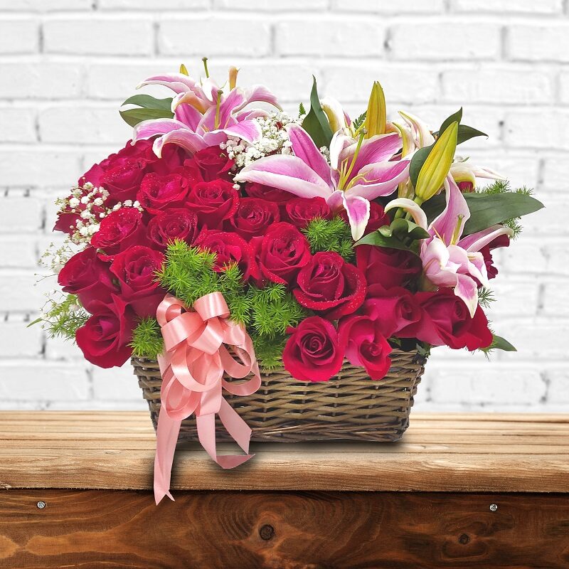 roses lilies in basket arrangement