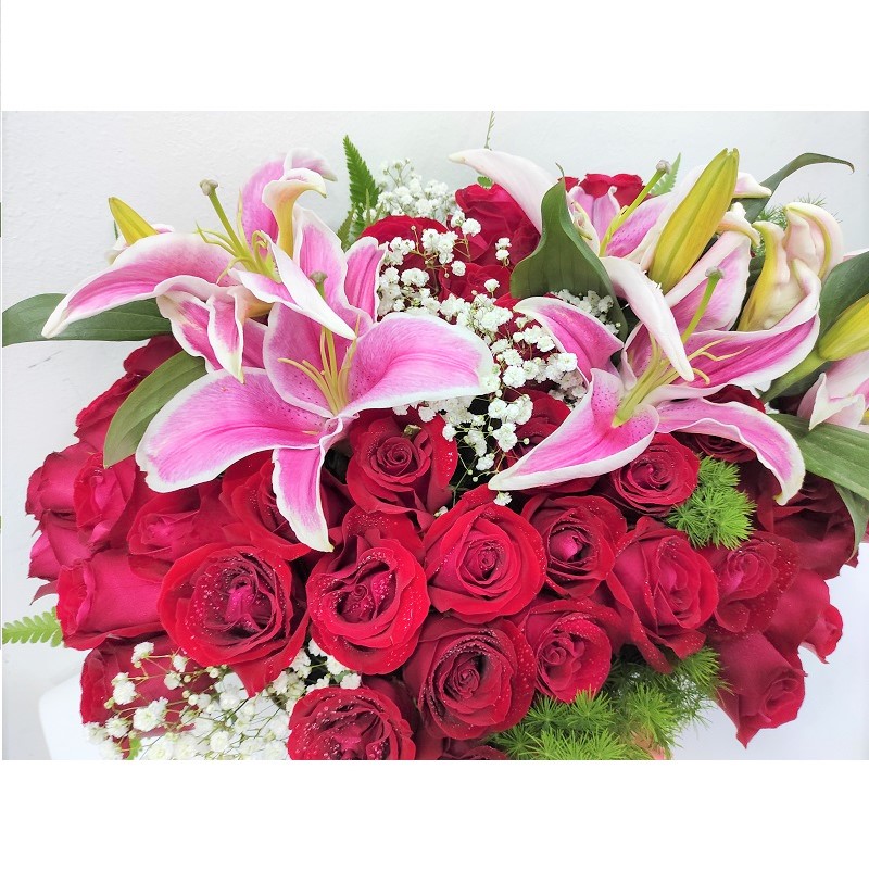 roses lilies in basket arrangement