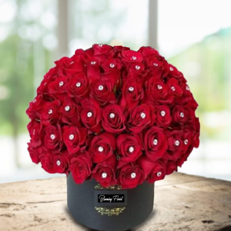 red roses decorated with diamond pin in a box